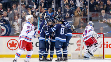 WINNIPEG, MB - FEBRUARY 12: Chris Kreider #20 of the New York Rangers skates away as Winnipeg Jets players celebrate a first period goal by Mark Scheifele #55 at the Bell MTS Place on February 12, 2019 in Winnipeg, Manitoba, Canada. (Photo by Jonathan Kozub/NHLI via Getty Images)