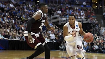March 24, 2016; Anaheim, CA, USA; Oklahoma Sooners guard Jordan Woodard (10) moves to the basket against Texas A&M Aggies guard Danuel House (23) during the second half of the semifinal game in the West regional of the NCAA Tournament at Honda Center. Mandatory Credit: Richard Mackson-USA TODAY Sports