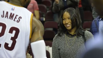 Dec 9, 2014; Cleveland, OH, USA; Cleveland Cavaliers forward LeBron James (23) talks to his wife Savannah Brinson (R) after defeating the Toronto Raptors 105-101 at Quicken Loans Arena. Mandatory Credit: David Richard-USA TODAY Sports