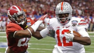 Ohio State quarterback Cardale Jones (12) runs as Alabama defensive back Landon Collins (26) defends the Sugar Bowl NCAA college football playoff semifinal game, Thursday, Jan. 1, 2015, in New Orleans. - Bill Haber/AP Photo