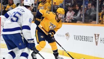 Nashville Predators center Tommy Novak (82) plays the puck behind the net during the first period against the Tampa Bay Lightning at Bridgestone Arena. Mandatory Credit: Christopher Hanewinckel-USA TODAY Sports