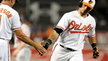 Aug 18, 2015; Baltimore, MD, USA; Baltimore Orioles outfielder Gerardo Parra (18) high fives third base coach Bobby Dickerson (11) after hitting a home run in the sixth inning against the New York Mets at Oriole Park at Camden Yards. Mandatory Credit: Evan Habeeb-USA TODAY Sports