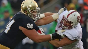 SOUTH BEND, IN - OCTOBER 13: Christian Lombard #74 of the Notre Dame Fighting Irish blocks Kevin Anderson #48 of the Standford Cardinal at Notre Dame Stadium on October 13, 2012 in South Bend, Indiana. Notre Dame defeated Stanford 20-13 in overtime. (Photo by Jonathan Daniel/Getty Images)