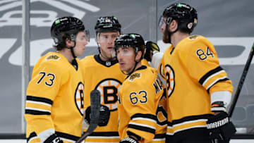 Apr 3, 2021; Boston, Massachusetts, USA; Boston Bruins center Brad Marchand (63) is congratulated by center Charlie Coyle (13) after scoring his third goal of the game against the Pittsburgh Penguins in the third period at TD Garden. Mandatory Credit: David Butler II-USA TODAY Sports