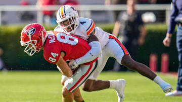 Auburn footballOct 8, 2022; Athens, Georgia, USA; Georgia Bulldogs wide receiver Ladd McConkey (84) is tackled by Auburn Tigers cornerback D.J. James (4) during the first quarter at Sanford Stadium. Mandatory Credit: Dale Zanine-USA TODAY Sports