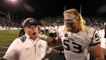Sep 5, 2014; Reno, NV, USA; Nevada Wolf Pack head coach Brian Polian celebrates with defensive end Brock Hekking (53) after Nevada defeated the Washington State Cougars at MacKay Stadium 24-13. Mandatory Credit: Lance Iversen-USA TODAY Sports.