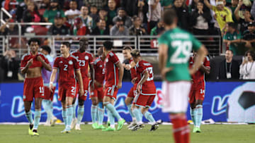 Mexico's Santi Giménez (No. 29) can only watch as Colombia celebrates its third goal of the match. (Photo by Omar Vega/Getty Images)