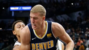 SAN ANTONIO,TX - OCTOBER 8: Mason Plumlee #24 of the Denver Nuggets tries to drive past Bryn Forbes #11 of the San Antonio Spurs at AT&T Center on October 8, 2017 in San Antonio, Texas. NOTE TO USER: User expressly acknowledges and agrees that , by downloading and or using this photograph, User is consenting to the terms and conditions of the Getty Images License Agreement. (Photo by Ronald Cortes/Getty Images)