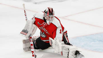 BOSTON, MA - FEBRUARY 13: Devon Levi #1 of the Northeastern Huskies makes a save during a game against the Harvard Crimson during NCAA hockey in the championship game of the annual Beanpot Hockey Tournament at TD Garden on February 13, 2023 in Boston, Massachusetts. The game officially ended in a 2-2 tie with the Huskies winning the shootout 1-0 to capture the title. (Photo by Richard T Gagnon/Getty Images)