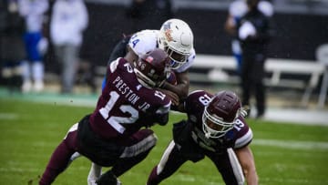Dec 31, 2020; Fort Worth, TX, USA; Tulsa Golden Hurricane running back Corey Taylor II (24) is tackled by Mississippi State Bulldogs safety Shawn Preston Jr. (12) and safety Collin Duncan (19) during the first half at Amon G. Carter Stadium. Mandatory Credit: Jerome Miron-USA TODAY Sports