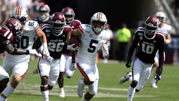 COLLEGE STATION, TEXAS - SEPTEMBER 21: Anthony Schwartz #5 of the Auburn Tigers rushes past Demani Richardson #26 of the Texas A&M Aggies and Myles Jones #10 for a 57 yard touchdown during the first quarter at Kyle Field on September 21, 2019 in College Station, Texas. (Photo by Bob Levey/Getty Images)