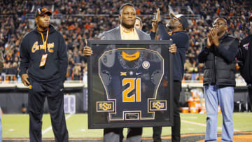 STILLWATER, OK - NOVEMBER 13: Former running back Barry Sanders #21 of the Oklahoma State Cowboys holds up a commemorative jersey as his name is unveiled in the Ring of Honor at Boone Pickens Stadium on November 13, 2021 in Stillwater, Oklahoma. Oklahoma State won 63-17. (Photo by Brian Bahr/Getty Images)