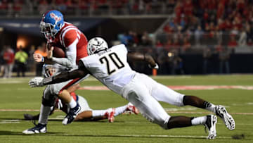 OXFORD, MS - SEPTEMBER 26: Chad Kelly #10 of the Mississippi Rebels avoids a tackle by Oren Burks #20 of the Vanderbilt Commodores during the fourth quarter of a game at Vaught-Hemingway Stadium on September 26, 2015 in Oxford, Mississippi. (Photo by Stacy Revere/Getty Images)