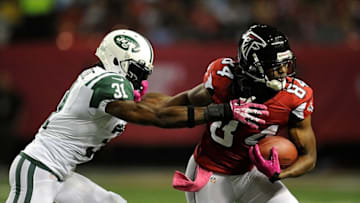 Oct 7, 2013; Atlanta, GA, USA; New York Jets cornerback Antonio Cromartie (31) tries to tackle Atlanta Falcons wide receiver Roddy White (84) during the second quarter at the Georgia Dome. Mandatory Credit: Dale Zanine-USA TODAY Sports