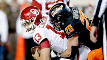 Oklahoma State's Malcolm Rodriguez (20) sacks Oklahoma's Caleb Williams (13) in the third quarter during a Bedlam college football game between the Oklahoma State University Cowboys (OSU) and the University of Oklahoma Sooners (OU) at Boone Pickens Stadium in Stillwater, Okla., Saturday, Nov. 27, 2021. OSU won 37-33.tramel JUMP