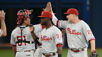 Jun 13, 2016; Toronto, Ontario, CAN; Philadelphia Phillies catcher Carlos Ruiz (51) and left fielder Cody Asche (25) high five beside center fielder Odubel Herrera (37) as the celebrate a 7-0 win over Toronto Blue Jays at Rogers Centre. Mandatory Credit: Dan Hamilton-USA TODAY Sports