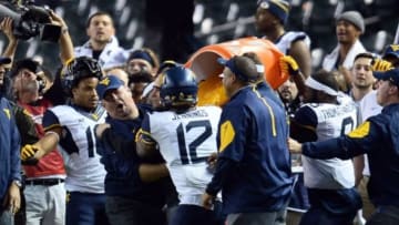 Jan 2, 2016; Phoenix, AZ, USA; West Virginia Mountaineers head coach Dana Holgorsen is doused with Gatorade during the second half of the 2016 Cactus Bowl against the Arizona State Sun Devils at Chase Field. The Mountaineers won 43-42. Mandatory Credit: Joe Camporeale-USA TODAY Sports