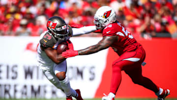 TAMPA, FL - NOVEMBER 10: Peyton Barber #25 of the Tampa Bay Buccaneers shoves off Terrell Suggs #56 of the Arizona Cardinals on a run during the game on November 10, 2019 at Raymond James Stadium in Tampa, Florida. (Photo by Will Vragovic/Getty Images)