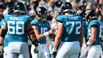 JACKSONVILLE, FLORIDA - JANUARY 09: Trevor Lawrence #16 of the Jacksonville Jaguars huddles up with his team during the second quarter in the game against the Indianapolis Colts at TIAA Bank Field on January 09, 2022 in Jacksonville, Florida. (Photo by Julio Aguilar/Getty Images)