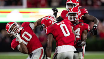 ATHENS, GA - NOVEMBER 5: Jamon Dumas-Johnson #10, Rian Davis #0 and Malaki Starks #24 of the Georgia Bulldogs celebrate a big stop during a game between Tennessee Volunteers and Georgia Bulldogs at Sanford Stadium on November 5, 2022 in Athens, Georgia. (Photo by Steve Limentani/ISI Photos/Getty Images)