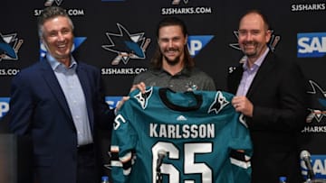 SAN JOSE, CA - SEPTEMBER 19: (L-R) General Manager Doug Wilson, Erik Karlsson, and head coach Peter DeBoer of the San Jose Sharks pose for a photo during a press conference at the Hilton on September 19, 2018 in San Jose, California (Photo by Brandon Magnus/NHLI via Getty Images)