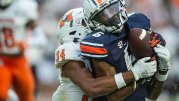 Auburn football wide receiver Ja'Varrius Johnson (6) comes down with a long pass as he is hit by Mercer Bears safety Myles Redding (34) as Auburn Tigers take on Mercer Bears at Jordan-Hare Stadium in Auburn, Ala., on Saturday, Sept. 3, 2022. Auburn Tigers leads Mercer Bears 28-7 at halftime.