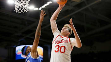 Cincinnati Bearcats center Viktor Lakhin rises for a dunk and gets fouled by Memphis Tigers forward Landers Nolley II. The Enquirer.