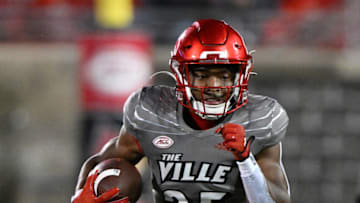 Nov 5, 2022; Louisville, Kentucky, USA; Louisville Cardinals running back Jawhar Jordan (25) runs the ball against the James Madison Dukes during the second half at Cardinal Stadium. Louisville defeated James Madison 34-10. Mandatory Credit: Jamie Rhodes-USA TODAY Sports