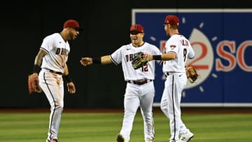 PHOENIX, ARIZONA - APRIL 26: David Peralta #6, Daulton Varsho #12 and Pavin Smith #26 of the Arizona Diamondbacks celebrate a 5-3 win against the Los Angeles Dodgers at Chase Field on April 26, 2022 in Phoenix, Arizona. (Photo by Norm Hall/Getty Images)