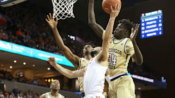 CHARLOTTESVILLE, VA - FEBRUARY 27: Ty Jerome #11 of the Virginia Cavaliers shoots between Khalid Moore #12 and Abdoulaye Gueye #34 of the Georgia Tech Yellow Jackets in the second half during a game at John Paul Jones Arena on February 27, 2019 in Charlottesville, Virginia. (Photo by Ryan M. Kelly/Getty Images)