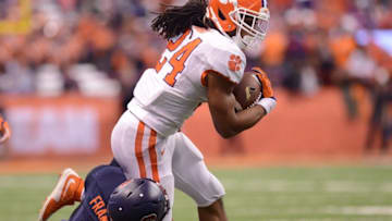 Nov 14, 2015; Syracuse, NY, USA; Clemson Tigers running back Zac Brooks (24) runs through the tackle of Syracuse Orange linebacker Zaire Franklin (4) during the fourth quarter of a game at the Carrier Dome. Mandatory Credit: Mark Konezny-USA TODAY Sports