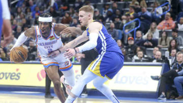 OKLAHOMA CITY, OKLAHOMA - JANUARY 30: Shai Gilgeous-Alexander #2 of the Oklahoma City Thunder drives past Donte DiVincenzo #0 of the Golden State Warriors during the second quarter at Paycom Center on January 30, 2023 in Oklahoma City, Oklahoma. NOTE TO USER: User expressly acknowledges and agrees that, by downloading and or using this photograph, User is consenting to the terms and conditions of the Getty Images License Agreement. (Photo by Ian Maule/Getty Images)