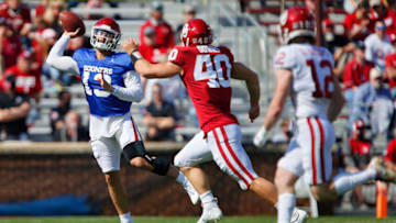 NORMAN, OK - APRIL 24: Quarterback Caleb Williams #13 of the Oklahoma Sooners looks to throw around defensive end Ethan Downs #40 of the Oklahoma Sooners to wide receiver Drake Stoops #12 during their spring game at Gaylord Family Oklahoma Memorial Stadium on April 24, 2021 in Norman, Oklahoma. (Photo by Brian Bahr/Getty Images)