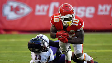 KANSAS CITY, MISSOURI - DECEMBER 09: Wide receiver Tyreek Hill #10 of the Kansas City Chiefs makes a catch as cornerback Anthony Averett #28 of the Baltimore Ravens defends during the game at Arrowhead Stadium on December 09, 2018 in Kansas City, Missouri. (Photo by Peter Aiken/Getty Images)