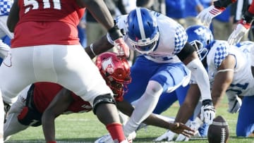 Nov 26, 2016; Louisville, KY, USA; Louisville Cardinals quarterback Lamar Jackson (8) scrambles to recover his fumbled football with Kentucky Wildcats linebacker Josh Allen (41) during the second half at Papa John