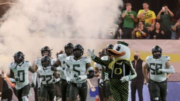 LAS VEGAS, NEVADA - DECEMBER 03: Defensive end Kayvon Thibodeaux #5 of the Oregon Ducks and the Ducks mascot The Duck lead the team onto the field for the Pac-12 Conference championship game against the Utah Utes at Allegiant Stadium on December 3, 2021 in Las Vegas, Nevada. The Utes defeated the Ducks 38-10. (Photo by Ethan Miller/Getty Images)