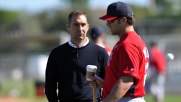 Feb 15, 2014; Jupiter, FL, USA; St. Louis Cardinals general manager John Mozeliak (left) listens to manager Mike Matheny (right) during spring training at Roger Dean Stadium. Mandatory Credit: Steve Mitchell-USA TODAY Sports