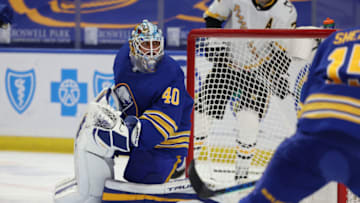 Mar 13, 2021; Buffalo, New York, USA; Buffalo Sabres goaltender Carter Hutton (40) looks for the loose puck during the first period against the Pittsburgh Penguins at KeyBank Center. Mandatory Credit: Timothy T. Ludwig-USA TODAY Sports