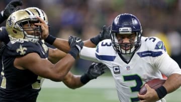 Oct 30, 2016; New Orleans, LA, USA; Seattle Seahawks quarterback Russell Wilson (3) stiff arms New Orleans Saints outside linebacker Craig Robertson (52) in the second half at the Mercedes-Benz Superdome. The Saints won, 25-20. Mandatory Credit: Chuck Cook-USA TODAY Sports