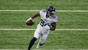 Nov 29, 2020; Indianapolis, Indiana, USA; Tennessee Titans wide receiver Corey Davis (84) runs with the ball after a catch against the Indianapolis Colts in the first half at Lucas Oil Stadium. Mandatory Credit: Trevor Ruszkowski-USA TODAY Sports