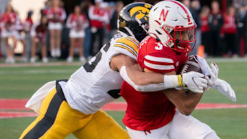 Nov 26, 2021; Lincoln, Nebraska, USA; Nebraska Cornhuskers wide receiver Samori Toure (3) is tackled by Iowa Hawkeyes defensive back Kaevon Merriweather (26) during the fourth quarter at Memorial Stadium. Mandatory Credit: Dylan Widger-USA TODAY Sports