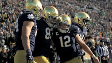SOUTH BEND, INDIANA - NOVEMBER 16: Chase Claypool #83 and Ian Book #12 of the Notre Dame Fighting Irish celebrate after scoring a touchdown in the first quarter against the Navy Midshipmen at Notre Dame Stadium on November 16, 2019 in South Bend, Indiana. (Photo by Dylan Buell/Getty Images)