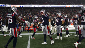 FOXBOROUGH, MA - OCTOBER 24: Mac Jones #10 of the New England Patriots high fives Nelson Agholor #15 prior to an NFL football game against the Chicago Bears at Gillette Stadium on October 24, 2022 in Foxborough, Massachusetts. (Photo by Kevin Sabitus/Getty Images)