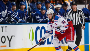 TORONTO, ON - MARCH 23: Mika Zibanejad #93 of the New York Rangers plays the puck against the Toronto Maple Leafs during the second period at the Scotiabank Arena on March 23, 2019 in Toronto, Ontario, Canada. (Photo by Mark Blinch/NHLI via Getty Images)
