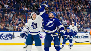 TAMPA, FL - JANUARY 17: Steven Stamkos #91 of the Tampa Bay Lightning reaches for the puck against Ron Hainsey #2 of the Toronto Maple Leafs during the first period at Amalie Arena on January 17, 2019 in Tampa, Florida. (Photo by Scott Audette/NHLI via Getty Images)