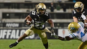 Nov 7, 2020; Boulder, Colorado, USA; Colorado Buffaloes running back Jarek Broussard (23) carries the ball past UCLA Bruins defensive back Stephan Blaylock (4) in the fourth quarter at Folsom Field. Mandatory Credit: Ron Chenoy-USA TODAY Sports