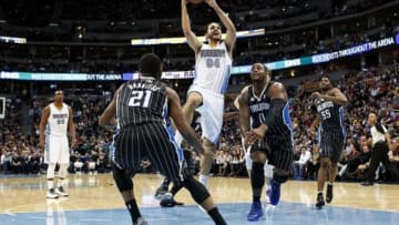 Jan 11, 2014; Denver, CO, USA; Denver Nuggets shooting guard Evan Fournier (94) drives to the net against Orlando Magic small forward Maurice Harkless (21) and power forward Glen Davis (11) in the second quarter at the Pepsi Center. Mandatory Credit: Isaiah J. Downing-USA TODAY Sports