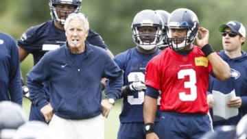 Jun 17, 2014; Renton, WA, USA; Seattle Seahawks head coach Pete Carroll and quarterback Russell Wilson (3) watch a scrimmage play during minicamp at the Virginia Mason Athletic Center. Mandatory Credit: Joe Nicholson-USA TODAY Sports