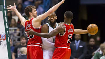 Apr 3, 2016; Milwaukee, WI, USA; Milwaukee Bucks center Greg Monroe (15) passes the ball from between Chicago Bulls center Pau Gasol (16) and forward Bobby Portis (5) during the first quarter at BMO Harris Bradley Center. Mandatory Credit: Jeff Hanisch-USA TODAY Sports