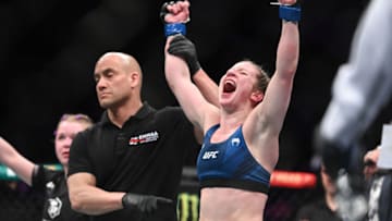 Mar 19, 2022; London, UK; Elise Reed (blue gloves) defeats Cory McKenna (red gloves) during UFC Fight Night at O2 Arena. Mandatory Credit: Per Haljestam-USA TODAY Sports